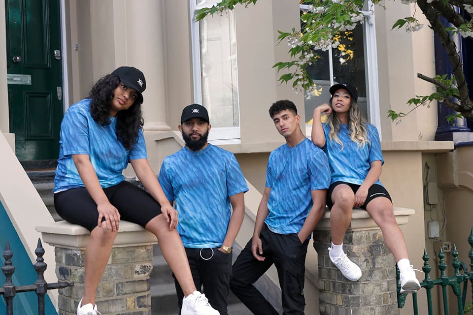 A range of models posing in blue print Askari clothing.